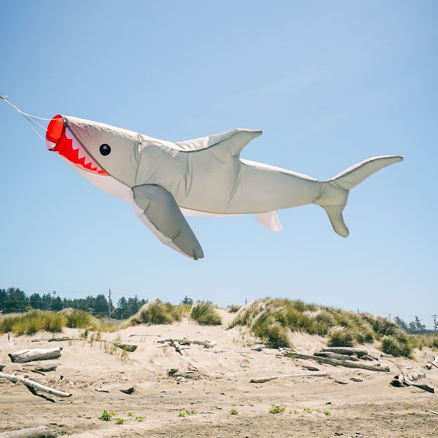 3D Shark Big Breeze WindsockTM in vibrant colors swaying in the breeze, designed for outdoor decoration and line laundry.