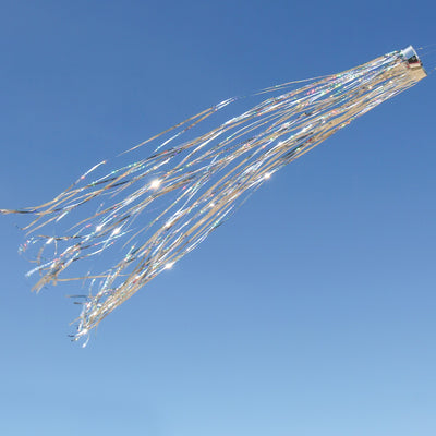 Silver 51" Mylar windsock fluttering elegantly in a garden, showcasing its bright holographic design under the sunlight.
