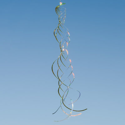 Silver Mylar Turbulence Spinner in a garden setting, showcasing its reflective surface and curlie design while spinning in the wind.