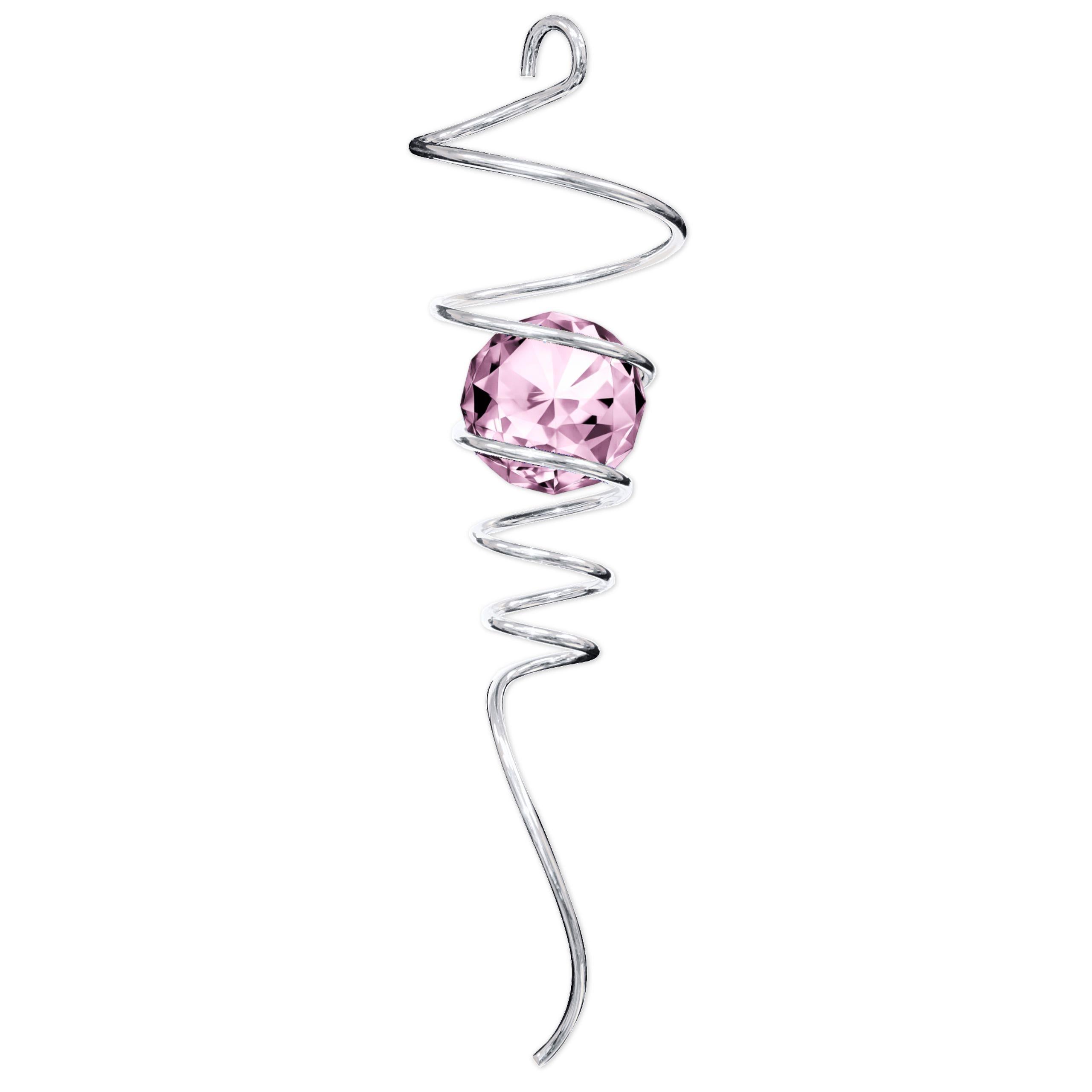 Silver Pink Tail with sparkling crystal and spiral design catching the light in an outdoor garden setting, enhancing the visual appeal of the space.