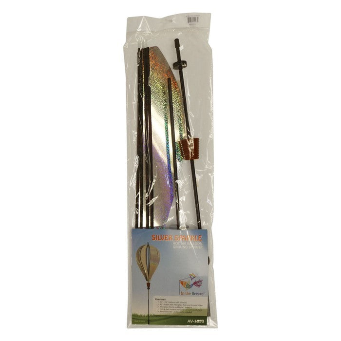 Silver Sparkle 6-Panel Hot Air Balloon Ground Spinner made of shimmering Mylar, elegantly displayed in a garden setting under sunlight.