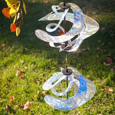 Silver Sparkle Vortex Double Spinner featuring interconnected Mylar spirals, elegantly spinning in an outdoor garden setting.