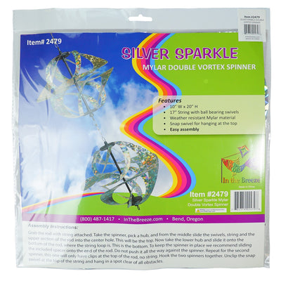 Silver Sparkle Vortex Double Spinner featuring interconnected Mylar spirals, elegantly spinning in an outdoor garden setting.