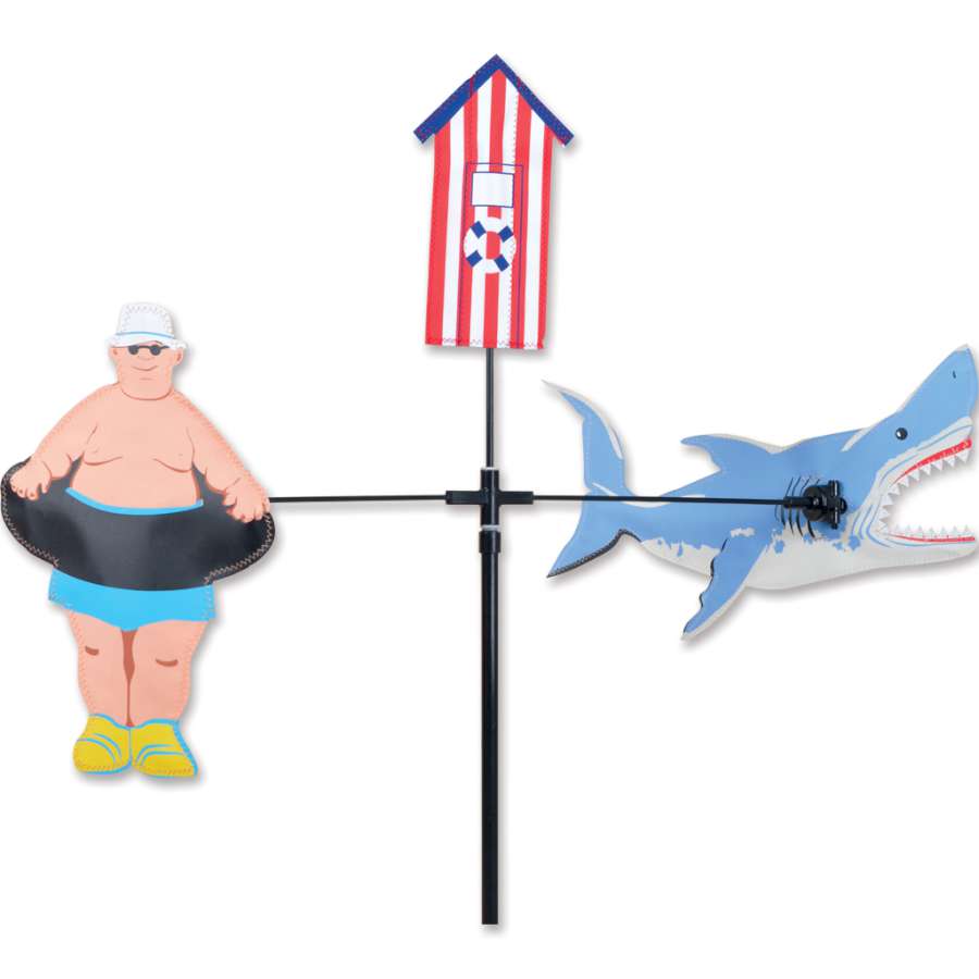 Single Carousel Spinner featuring a bright shark design, spinning in a garden setting with a clear blue sky in the background.