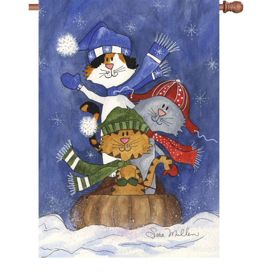 28-inch illuminated Sledding Friends house flag featuring playful cats sledding in a snowy scene, displayed on a garden flagpole.