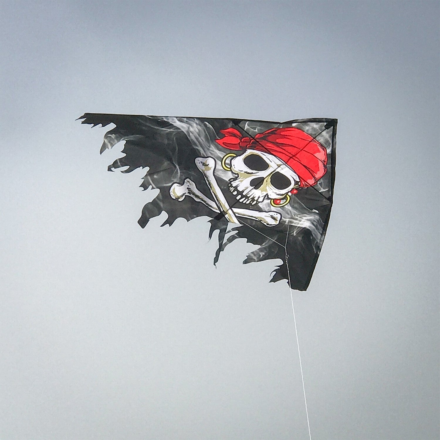 Smokin' Pirate Fringe Delta Kite featuring Jolly Roger graphics, 50 inches in size, ideal for family excursions and adventures in the sky.