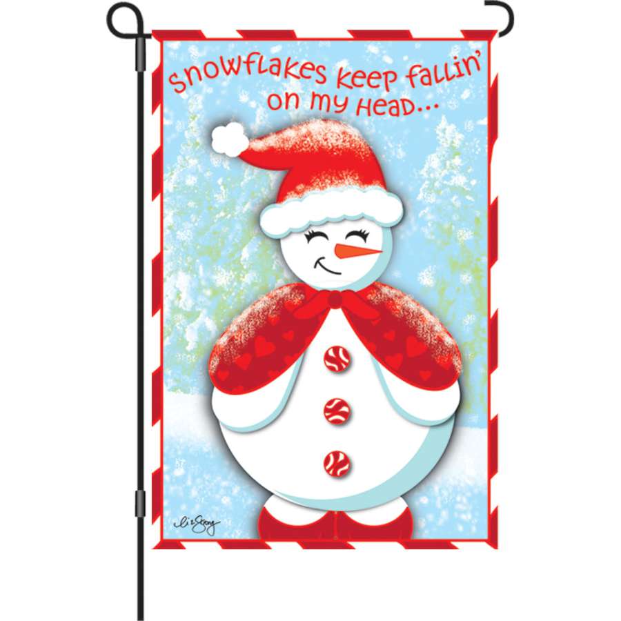 Snow Cutie garden flag featuring a cheerful snowman and snowflakes displayed outdoors, measuring 12 inches for winter decor.