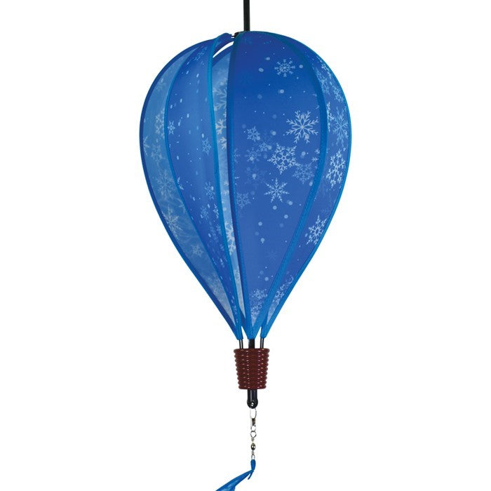 Snowflakes 6-Panel Hot Air Balloon spinner with a vibrant snowflake design, spinning gracefully in an outdoor winter setting, showcasing its festive charm.