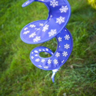 Snowman with Hat Hanging Ball Spinner in a garden setting, showcasing colorful panels and a cheerful, embroidered face, perfect for winter decoration.