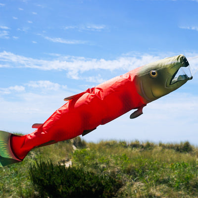 Sockeye Salmon 48-inch Fish Windsock featuring vibrant colors and detailed design, fluttering in the breeze at a marina.