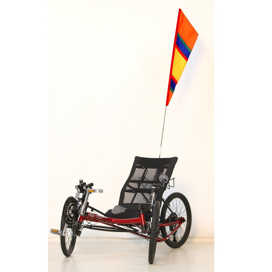 SoundWinds Fanion Recumbent Bike Flag in bright orange, measuring 9 inches by 33 inches, displayed on a recumbent bike with a fiberglass pole.