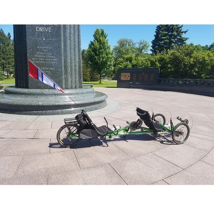SoundWinds Reflective Fanion Recumbent Bike Flag in red, measuring 9x33.5 inches, displayed on a bike, enhancing visibility and safety on the road.