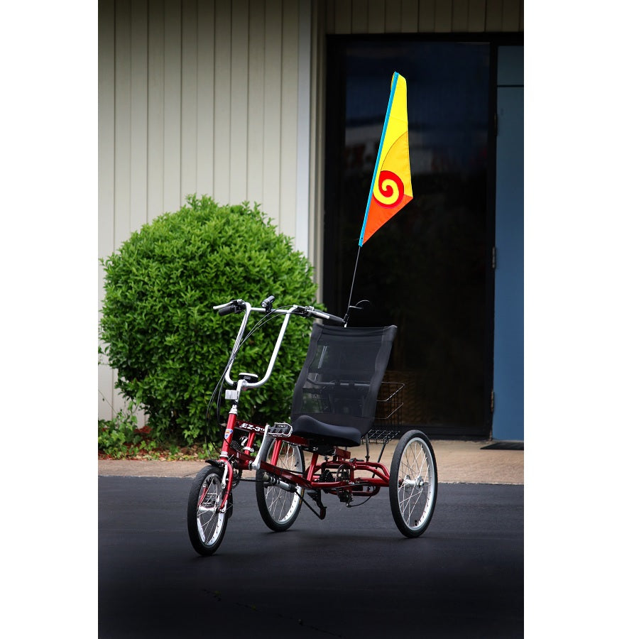 SoundWinds Spiral Recumbent Bike Flag displayed in a bright yellow color attached to a bicycle, featuring a durable pole designed for outdoor cycling.