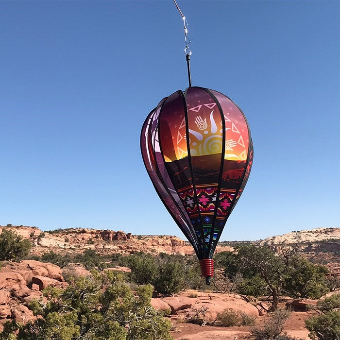 Southwest 10-Panel Hot Air Balloon Spinner in colorful geometric designs, spinning in a garden setting, showcasing vibrant outdoor decor.