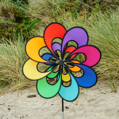 Spectrum Double Windee Wheelz rainbow petal spinner displayed in a garden, showing vibrant petals spinning joyfully in the breeze.