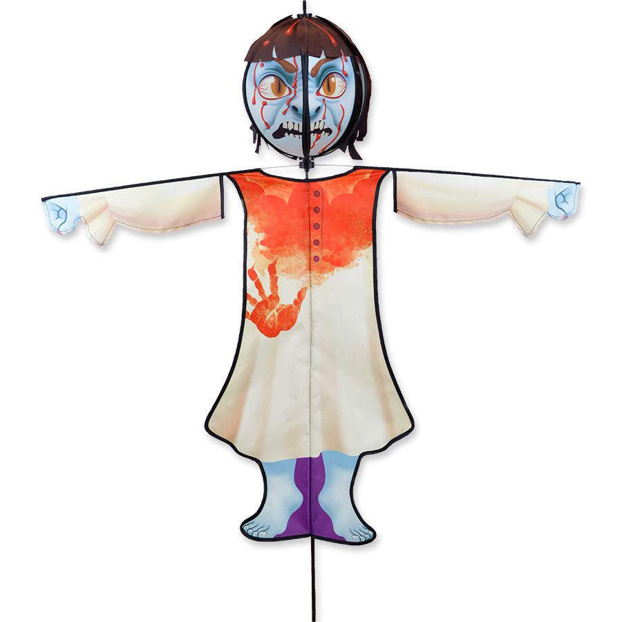Spinning Friend - Possessed Child Halloween spinner decoration with a spooky animated head placed in an outdoor garden setting, spinning in the wind.