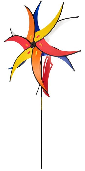 Spinning Sun Jester features two 27-inch colorful wheels and a rotating windsail, secured with a fiberglass rod in a beautiful garden setting.