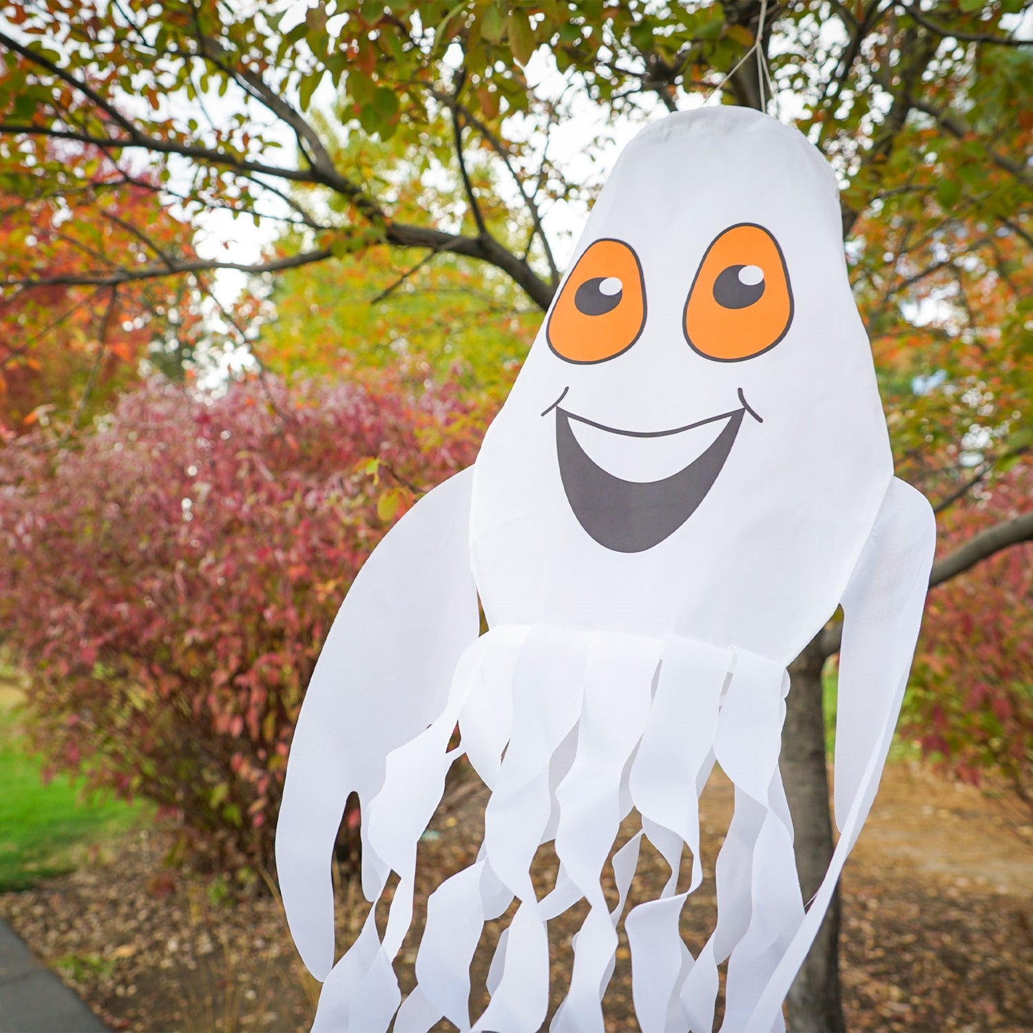 Spook the Ghost 3D Windsock hanging outdoor, featuring a cheerful ghost design with fluttering streamer tails perfect for Halloween decor.