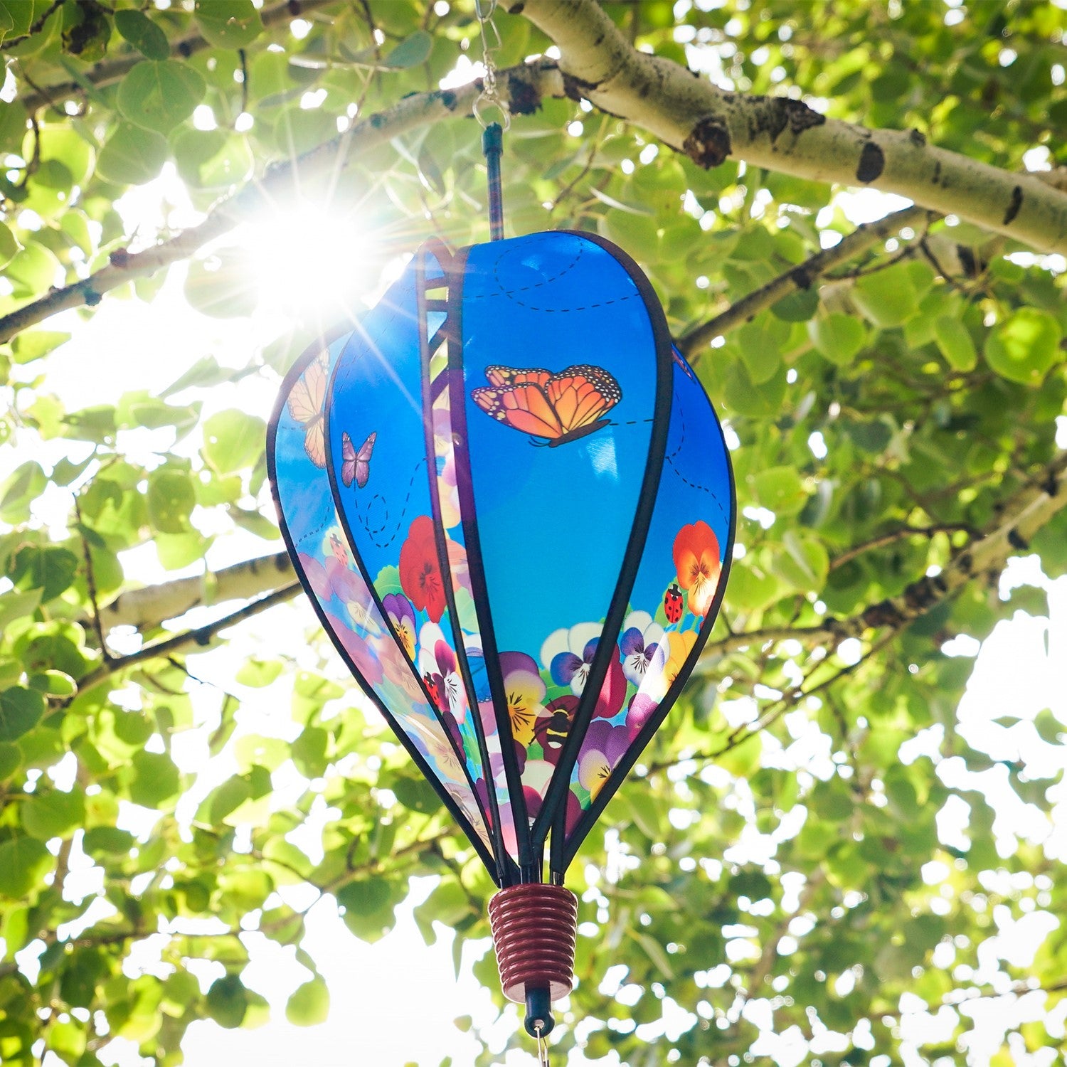 Colorful Spring Pansies 6-Panel Hot Air Balloon spinner in outdoor setting, showcasing bright floral patterns and spinning gracefully.
