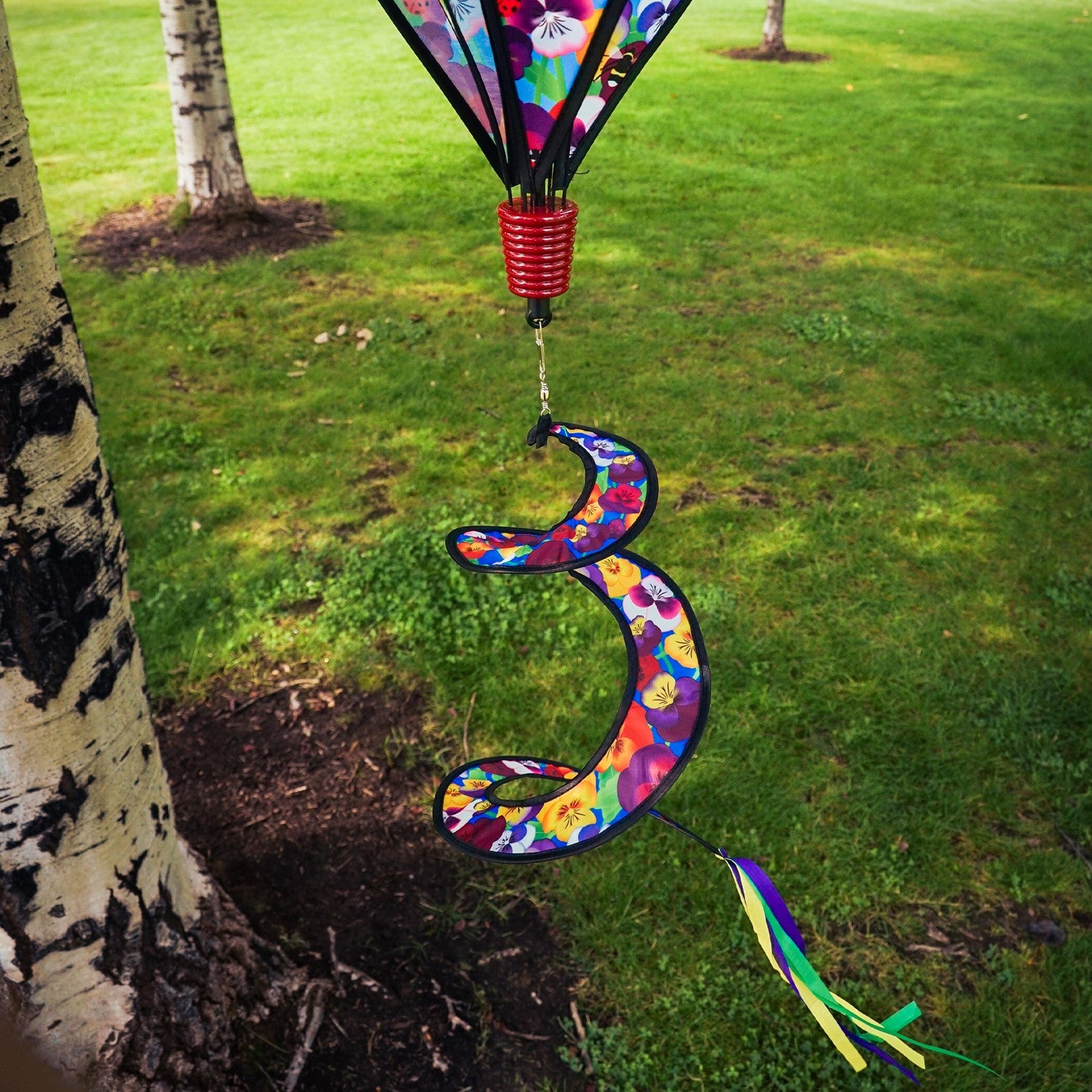 Colorful Spring Pansies 6-Panel Hot Air Balloon spinner in outdoor setting, showcasing bright floral patterns and spinning gracefully.
