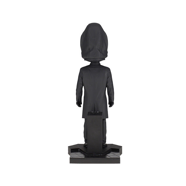 8-inch Squid Games Front Man Bobblehead featuring intricate details, black outfit, and mask, displayed prominently on a shelf.