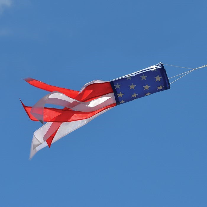 Stars & Stripes 24\" Windsock with vibrant red, white, and blue colors featuring silk-screened stars, hanging gracefully outdoors.