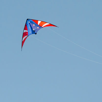 Stars & Stripes 48-inch sport kite with red, white, and blue design flying against a blue sky, showcasing its vibrant colors and dual control.