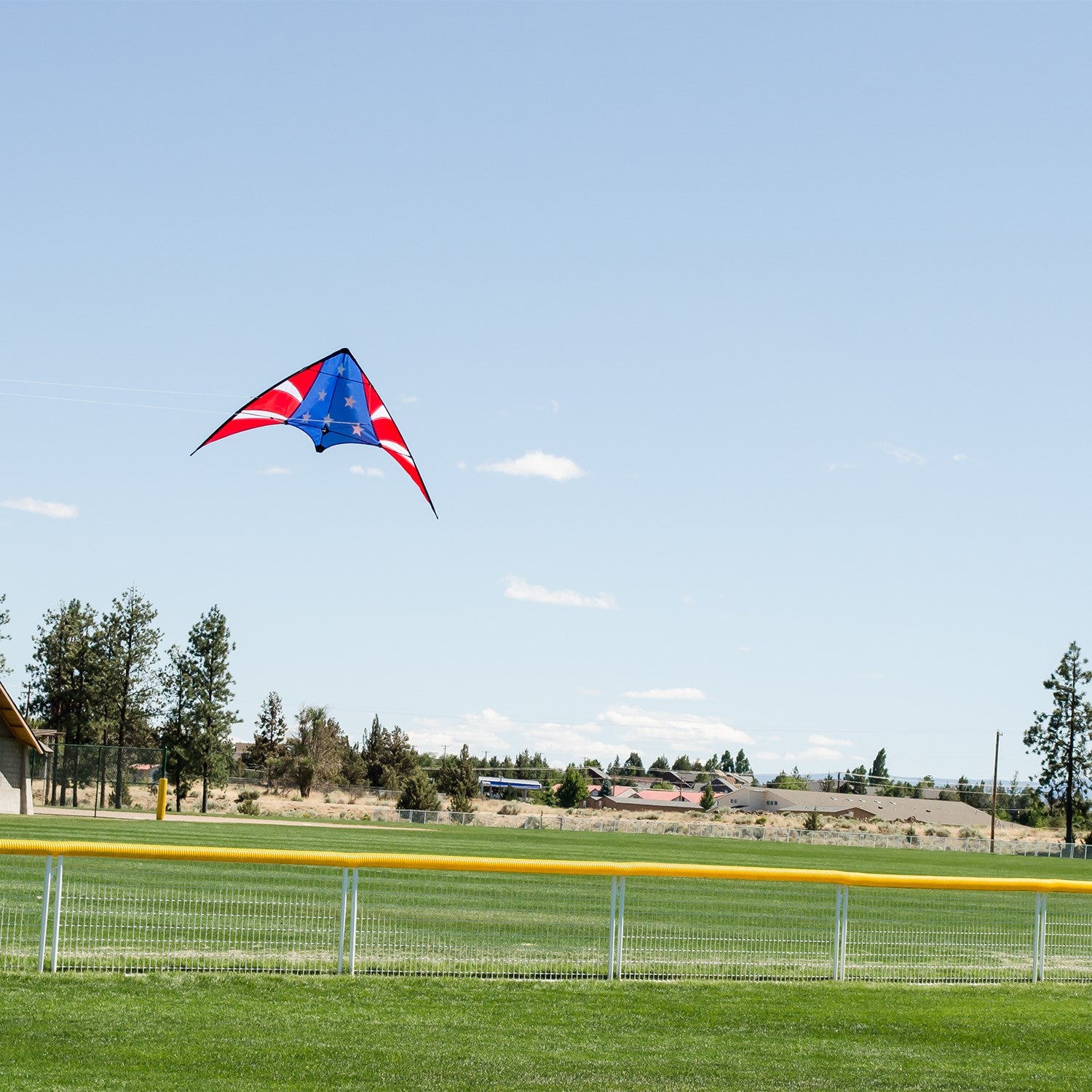 Stars & Stripes 48-inch sport kite with red, white, and blue design flying against a blue sky, showcasing its vibrant colors and dual control.