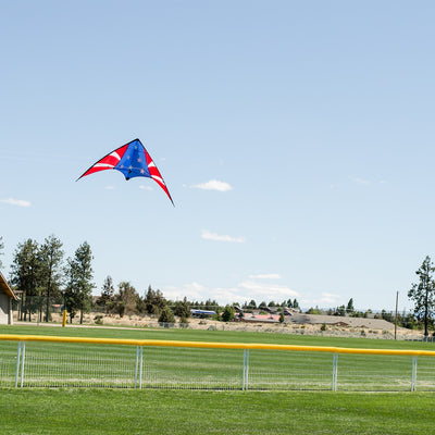Stars & Stripes 48-inch sport kite with red, white, and blue design flying against a blue sky, showcasing its vibrant colors and dual control.