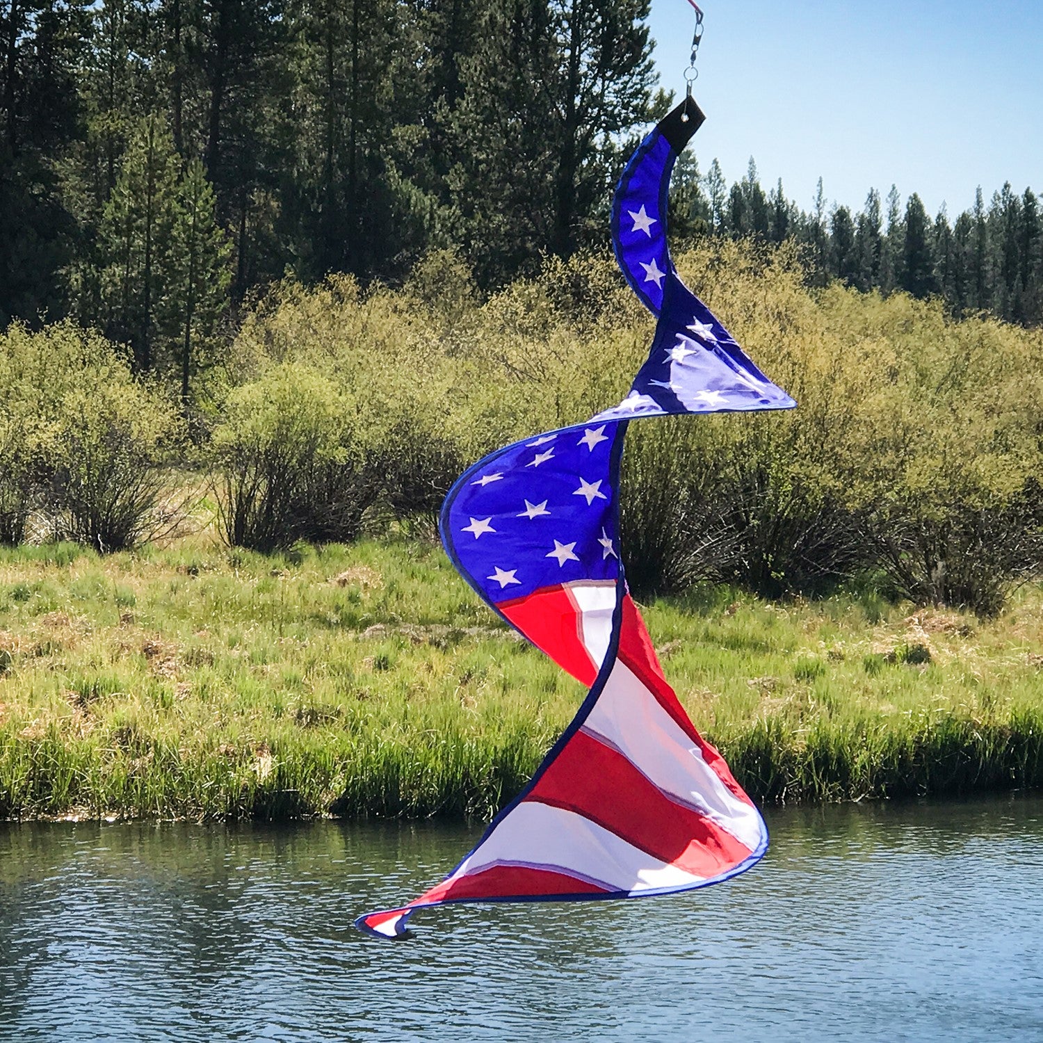 Stars & Stripes Solo Spinner hanging outdoors, showcasing the American flag design with vibrant red, white, and blue colors in motion.