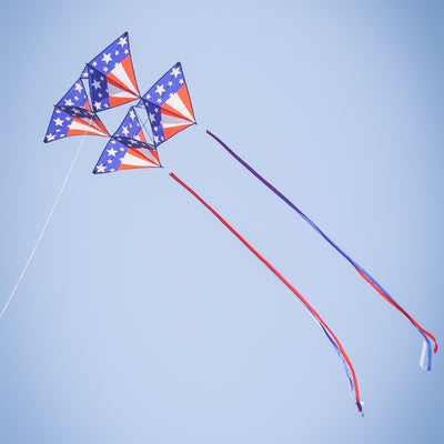 Stars & Stripes Tri-Kite soaring in the sky, featuring a vibrant red, white, and blue design, perfect for outdoor family activities.
