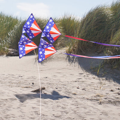 Stars & Stripes Tri-Kite soaring in the sky, featuring a vibrant red, white, and blue design, perfect for outdoor family activities.