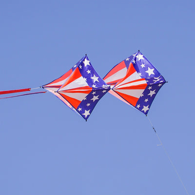 Stars & Stripes Tri-Kite soaring in the sky, featuring a vibrant red, white, and blue design, perfect for outdoor family activities.