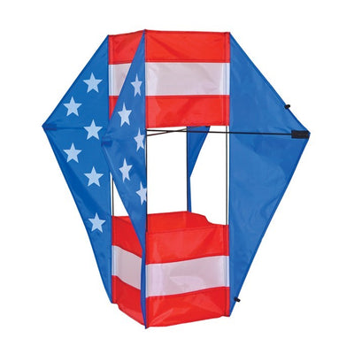 Stars & Stripes Winged Box Kite with a vibrant red, white and blue design soaring against a clear blue sky during an outdoor event.