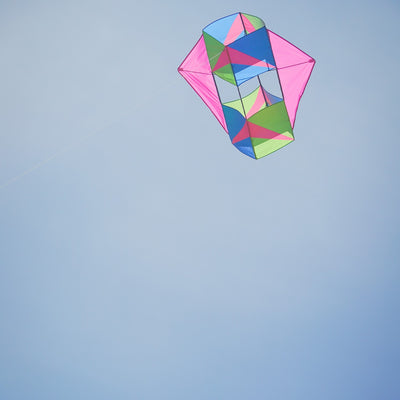 "Strike Winged Double Box Kite with vibrant design and wings displayed flying in a clear blue sky, showcasing its stability and durability.