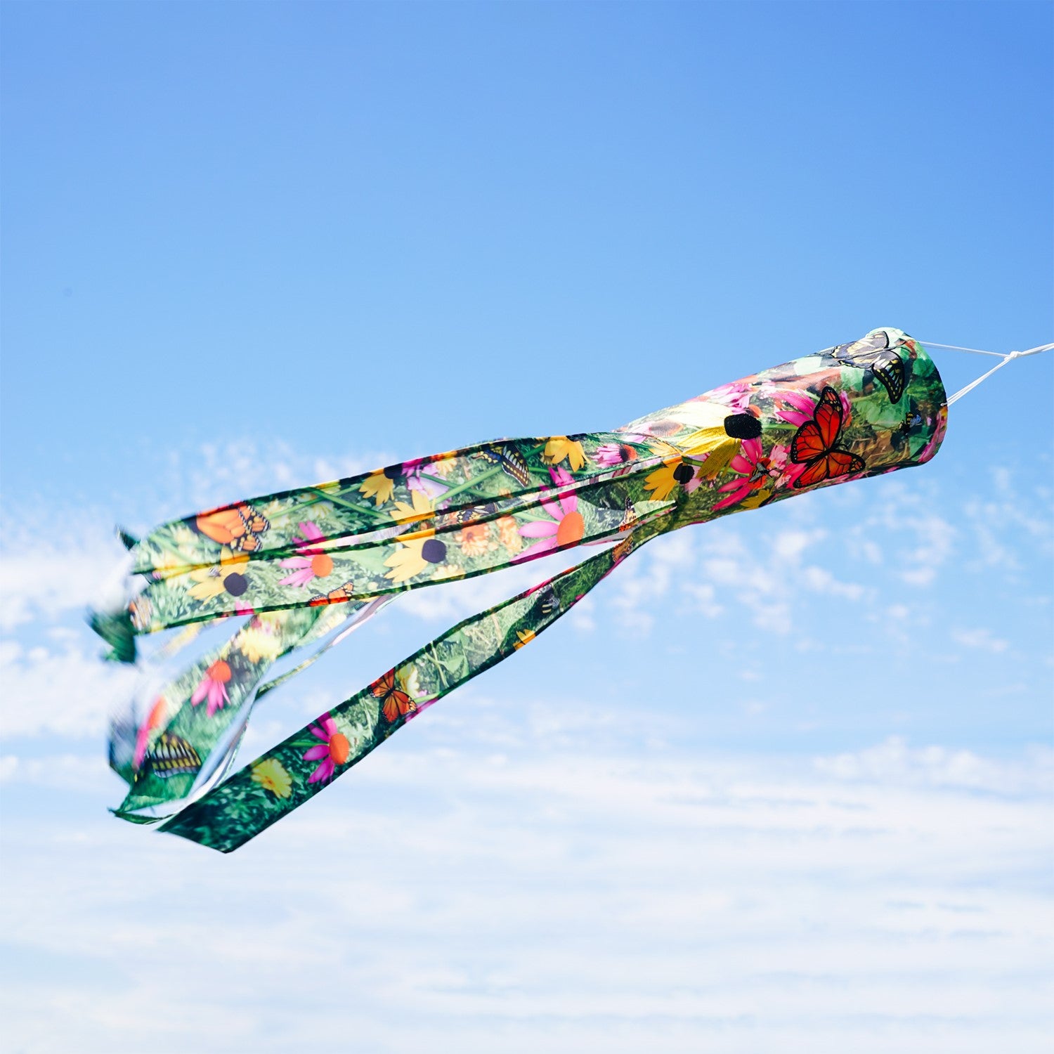 Summer Garden 40-Inch Illusion Windsock with vibrant printed design and embroidered details, gracefully hanging outdoors in a sunny garden setting.