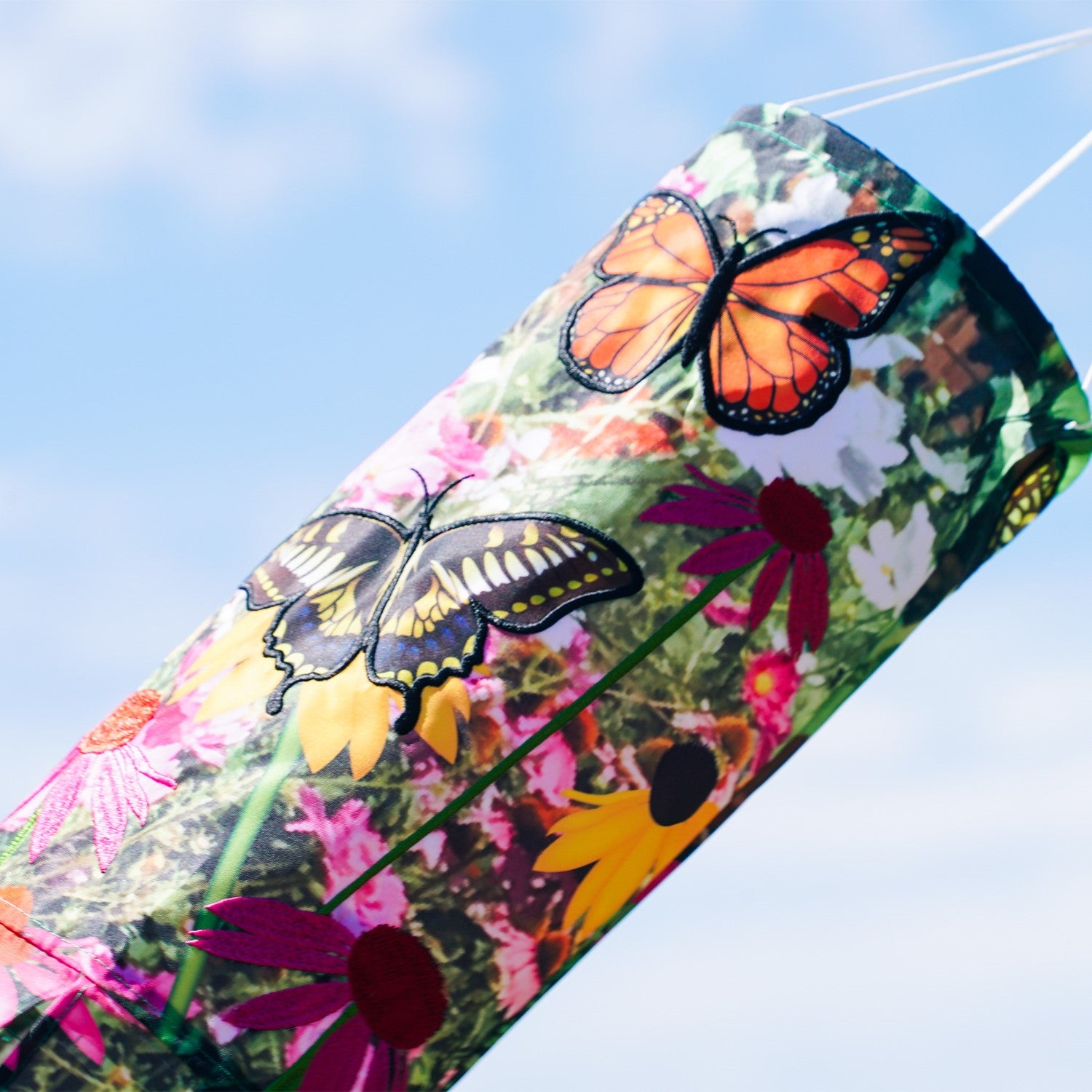 Summer Garden 40-Inch Illusion Windsock with vibrant printed design and embroidered details, gracefully hanging outdoors in a sunny garden setting.