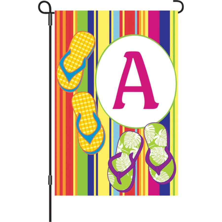 12 in. Summer Monogram Flag - A displayed in a garden setting, featuring a vibrant monogram design against a colorful background.