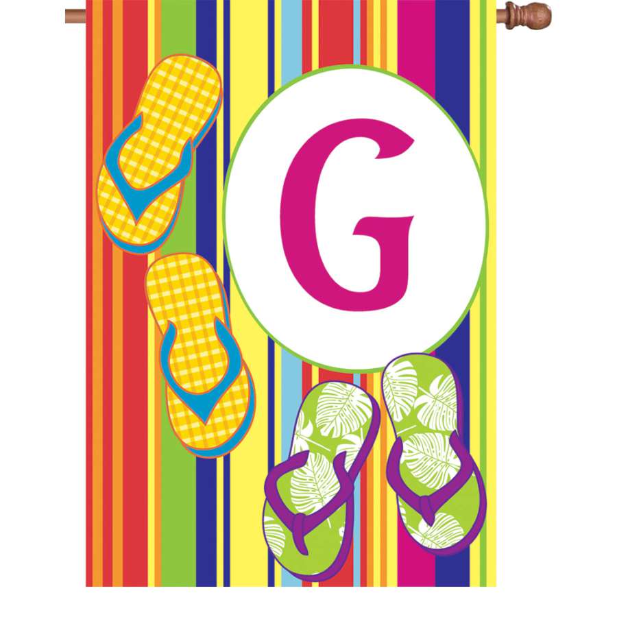 28 in. Summer Monogram Flag - G displayed on a pole, featuring a vibrant and beautifully designed monogram in a sunny garden setting.