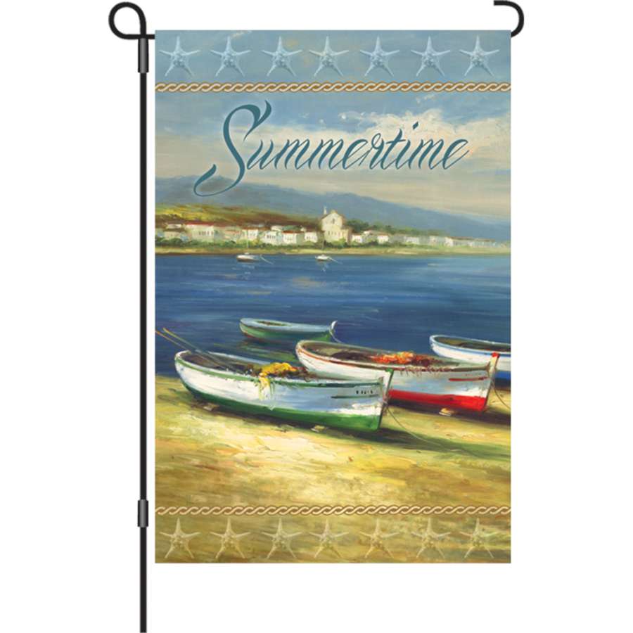 12 in. Summertime Boats garden flag with vibrant colors displayed in a garden setting, showing boats against a sunny backdrop.