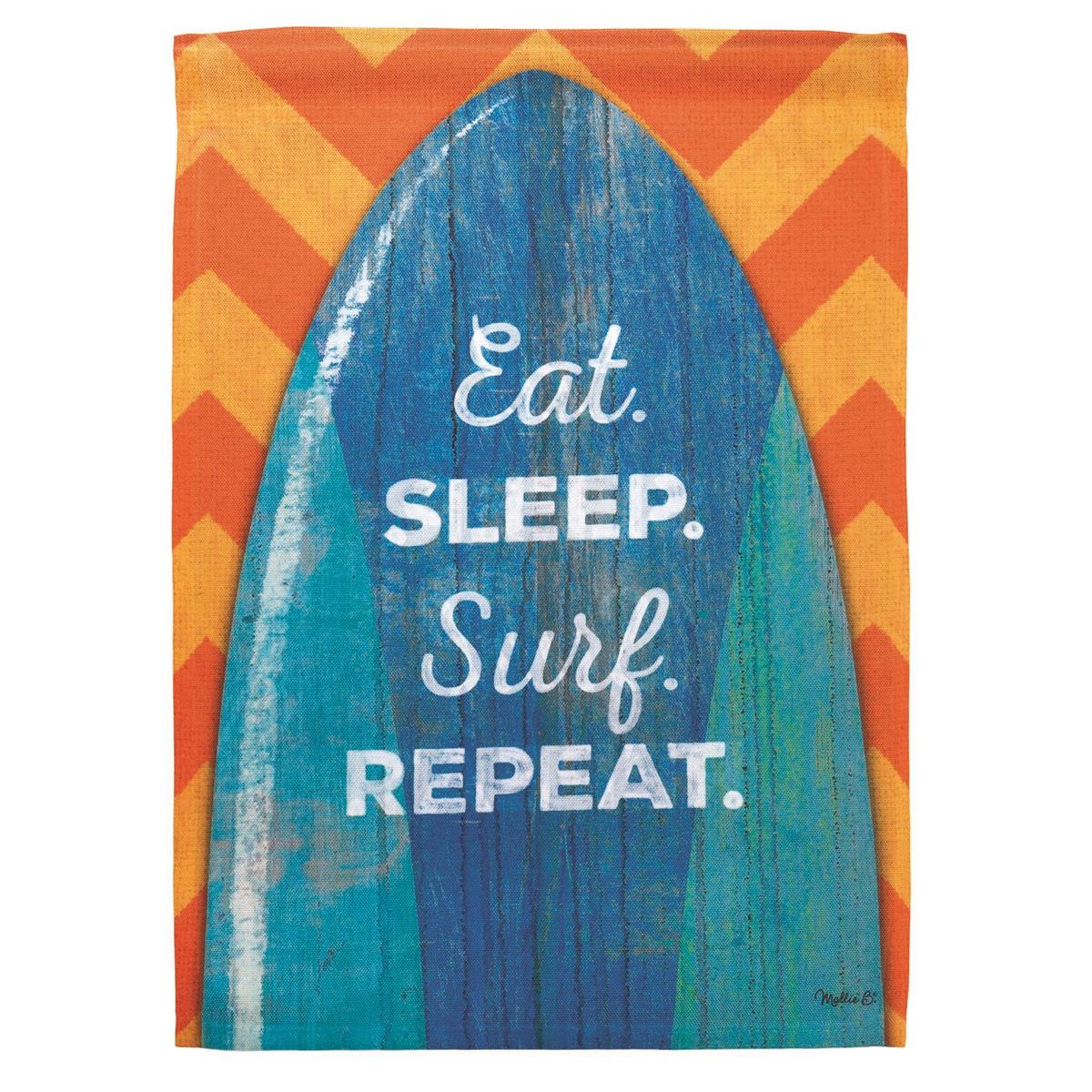 Surf Board Eat Sleep Garden Flag displayed in a garden setting, featuring a vibrant surfboard design with sunlight illuminating its colors.