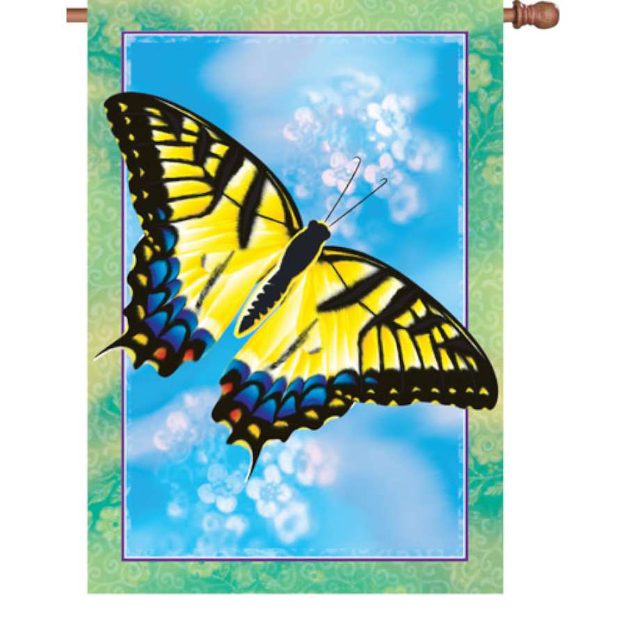 28-inch Swallowtail Butterfly flag featuring vibrant colors and designs, displayed in a garden setting on a flagpole.