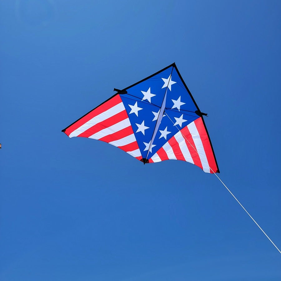 Sweet 16 Delta kite measuring 192 x 96 inches, displaying vibrant patriotic colors against a clear blue sky during a sunny day.