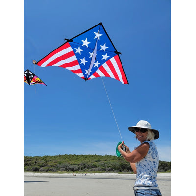 Sweet 16 Delta kite measuring 192 x 96 inches, displaying vibrant patriotic colors against a clear blue sky during a sunny day.