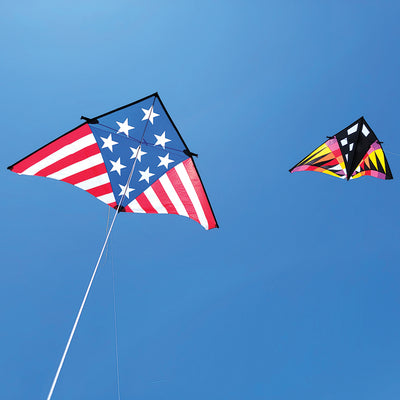 Sweet 16 Delta kite measuring 192 x 96 inches, displaying vibrant patriotic colors against a clear blue sky during a sunny day.