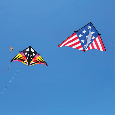 Sweet 16 Delta Kite in Sunrise Check design soaring in a blue sky with a vibrant tail fluttering in the wind, measuring 192 x 96 inches.