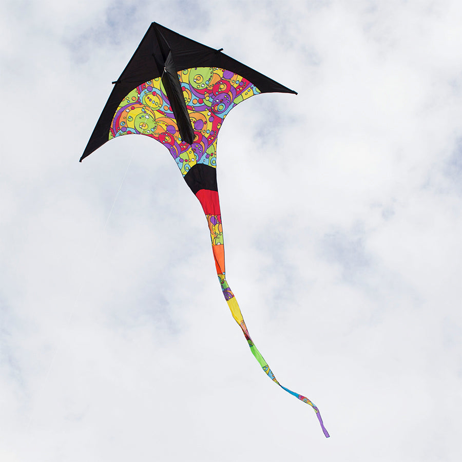 T-Delta Kite - Rainbow Orbit displayed soaring high in a blue sky, showcasing its vibrant colors and delta shape at the park.