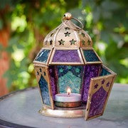 Teal & Purple Hex Glass Tealight Lantern featuring intricate glass and metal design, ready for use to illuminate indoor or outdoor spaces.