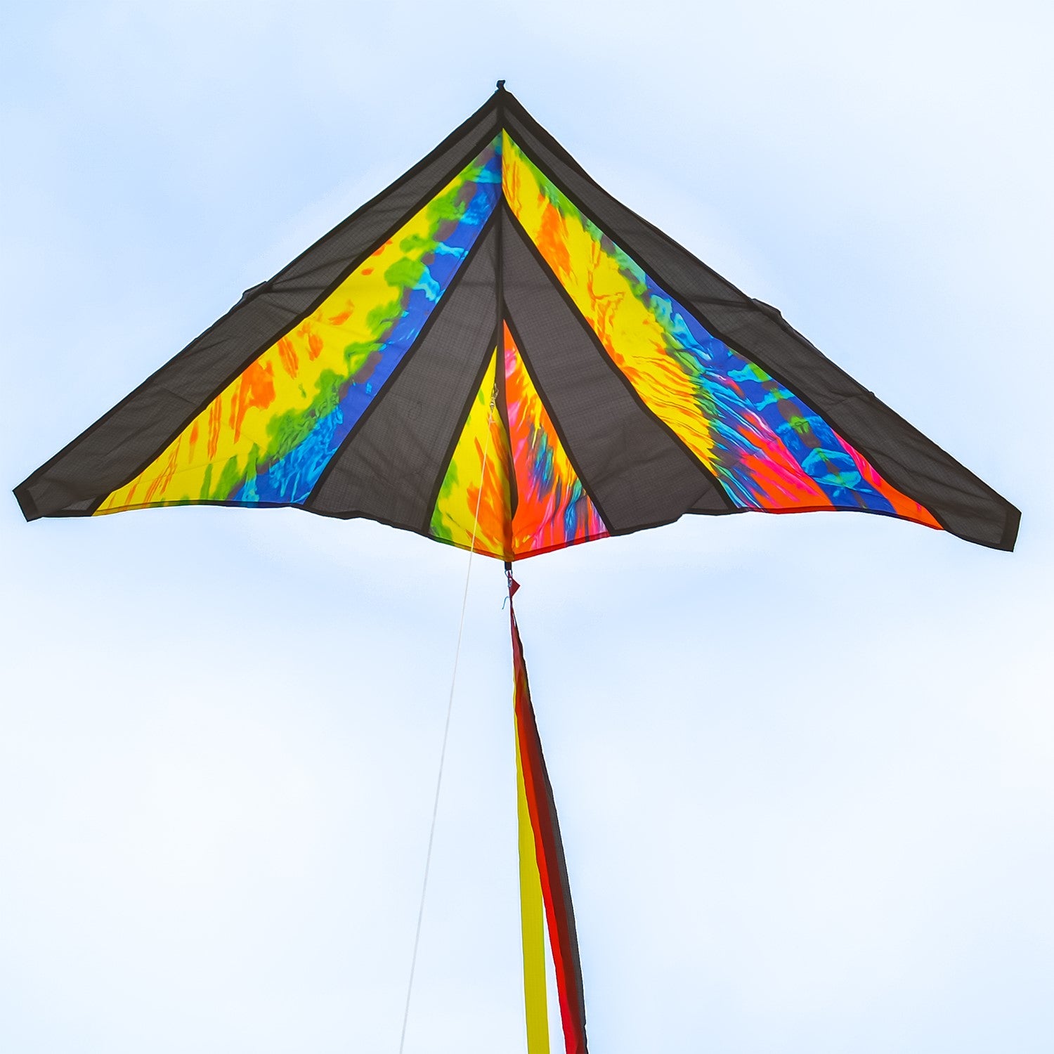 Tie Dye 46" Delta Kite soaring against a blue sky, featuring colorful streamer tails and tie-dye pattern, ideal for outdoor fun.