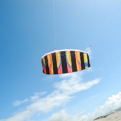 Tie Dye 62\" Sport Air Foil kite soaring in the sky, showcasing bright colors and intricate patterns against a clear blue background.